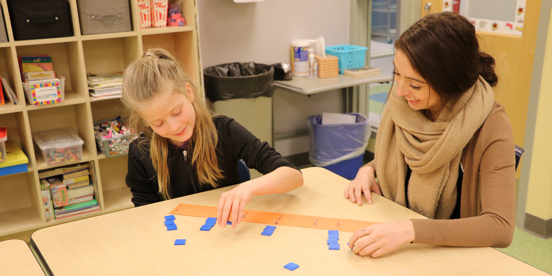 Student teacher teaches a student about fractions with a number line