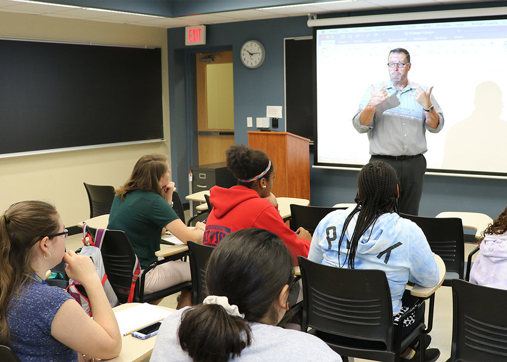 Teacher speaks to high school students in classroom